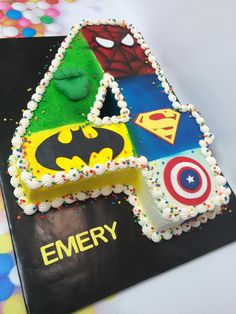 a birthday cake decorated to look like the letter e with superheros and captain america on it