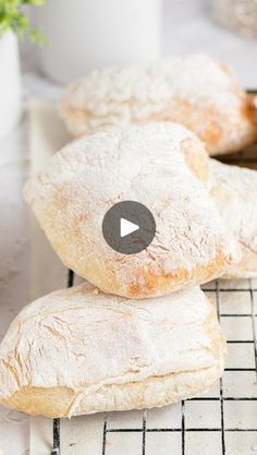 two loaves of bread stacked on top of each other in front of a potted plant