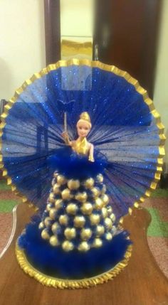 a blue and gold fan sitting on top of a wooden table