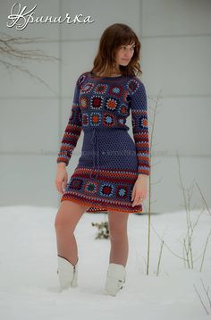 a woman is standing in the snow wearing a dress and white boots with her hands on her hips