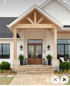 the front entrance to a house with two large doors