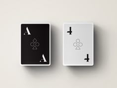 two white and black playing cards with symbols on them