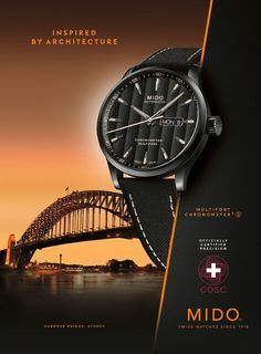 a black watch with an orange stripe on the strap and bridge in the background that says mido