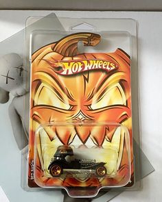 a toy car with an angry face on it's front and back sides in the package