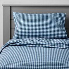 a bed with blue and white checkered sheets