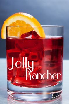 a close up of a drink in a glass with an orange slice on the rim