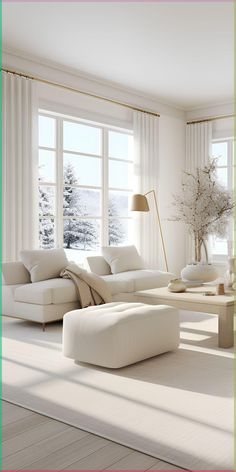 a living room with white furniture and large windows