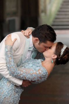 a bride and groom kissing on the dance floor