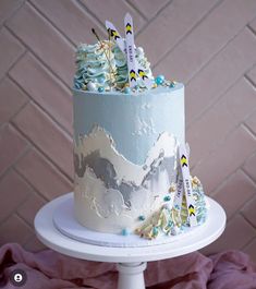 a blue and white cake sitting on top of a table