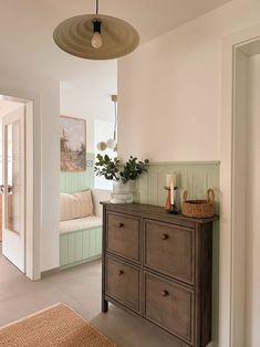 a living room with a dresser and couch in it