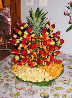 a platter filled with fruit and veggies on a table