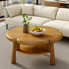 a living room with white couches and a wooden coffee table in the center area