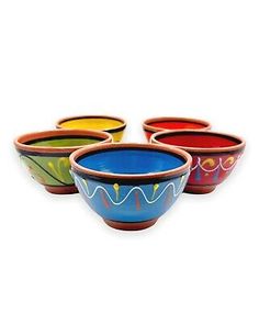 four colorful bowls sitting next to each other