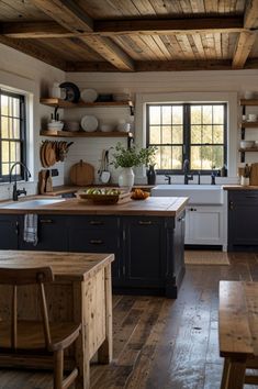 a kitchen with wooden floors and white walls