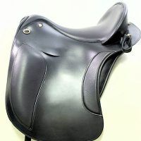 a close up of a black saddle on a white surface with no people around it