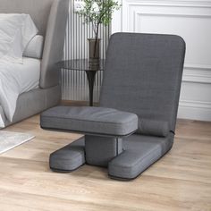 a grey chair and ottoman in a bedroom