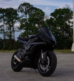 a black motorcycle parked in a parking lot