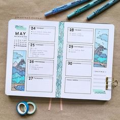 an open planner with some scissors and markers