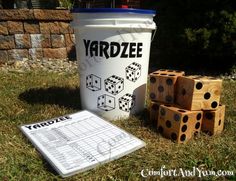 yardzee game in the grass next to a bucket with dices on it