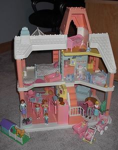 a toy doll house with furniture and accessories