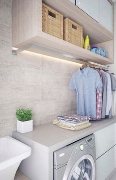 a washer and dryer in a bathroom with shelves on the wall above it