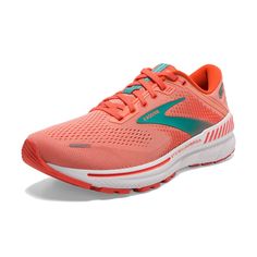 a woman's running shoe with an orange and green color scheme on the side