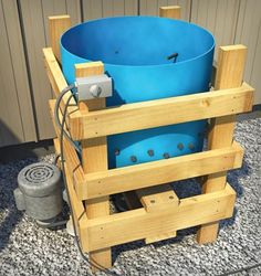 a large blue bucket sitting on top of a wooden pallet