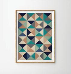 a framed art print with an abstract geometric design in blue, green and beige colors