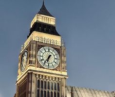 a large clock tower on top of a building with sky in the backround