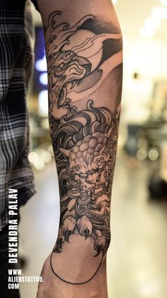 a man with a dragon tattoo on his arm