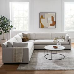 a living room with white walls and wood floors