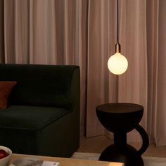 a living room with a couch, table and lamp in it's centerpiece