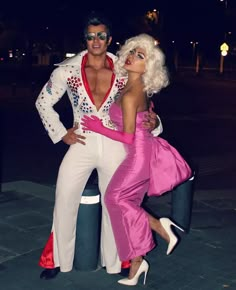 two people dressed in costumes standing next to each other