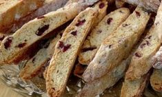 some very tasty looking bread sticks with berry toppings on them in a glass dish