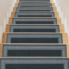 a set of stairs with carpeted treads and greek border