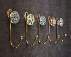 five decorative hooks are hanging on the wall