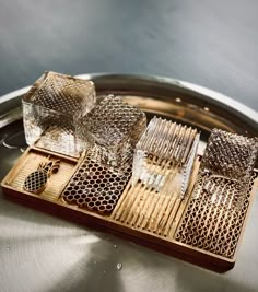 several pieces of glass sitting on top of a metal tray