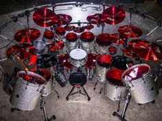 a drum set is shown with red lights on the drums and pedals in front of it