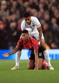 two soccer players on the field during a game