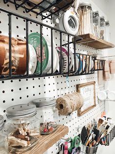 there are many craft supplies hanging on the wall