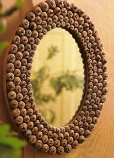 a mirror that is on the side of a wooden table next to a potted plant