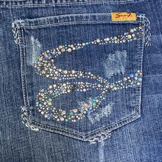 Sharp Classic Pair Of Jeans To Dress Up Or Down! Washed Once In Cold Water Due To Dust Bunnies On The Cuffs; Dried On Lowest Dryer Setting, Never Worn. Mid-Rise Medium Distressed Wash; Medium-Heavyweight Denim With A Moderate Stretch. Missing A Few Crystals, But Plenty Of Bling Remaining; Silver And Light Blue Metallic Accent Thread Details. Truest Shade Reflected In First 2 Photos. Lying Flat Measure 17" Across The Waist (18.75" When Waistband Straightened), 9.75" Rise, 31.5" Inseam, 9.75" Leg Jeans With Rhinestones, Bling Denim, Dust Bunnies, Stanley Cups, Bling Jeans, Low Rise Jeans, 2 Photos, Metallic Accents, Fern