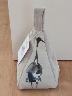 a bag with a painting on it sitting on the floor