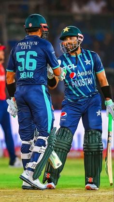 two men in blue uniforms standing next to each other