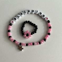 a black and pink beaded bracelet with a star charm