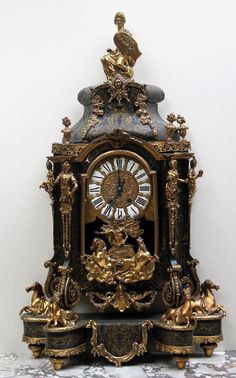 an ornate clock is sitting on a table