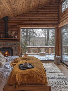 a bed sitting inside of a bedroom next to a fire place on top of a wooden floor