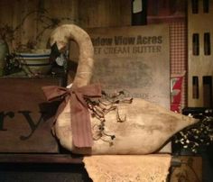 a swan shaped object sitting on top of a wooden box