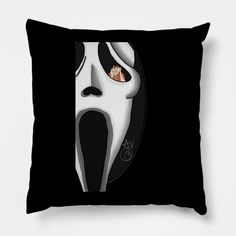 a black pillow with a white mask on it