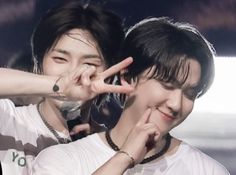 two people making the v sign with their hands